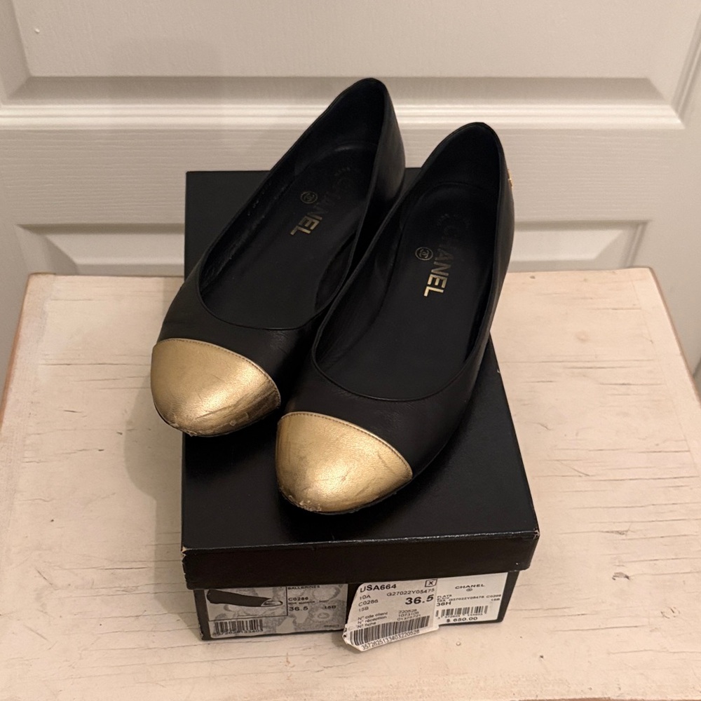 CHANEL Black Flats with Gold Toe Cap